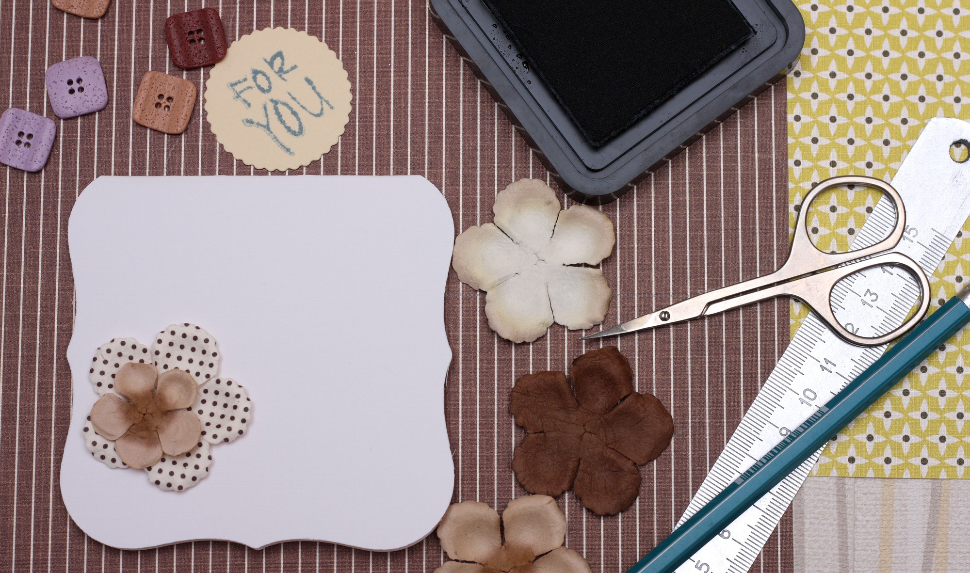 Flat lay of embroidered samples and pricing sheet
